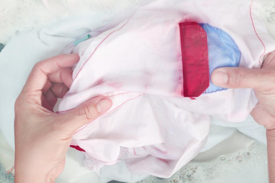 Holding clothes with red and blue dye bleeding