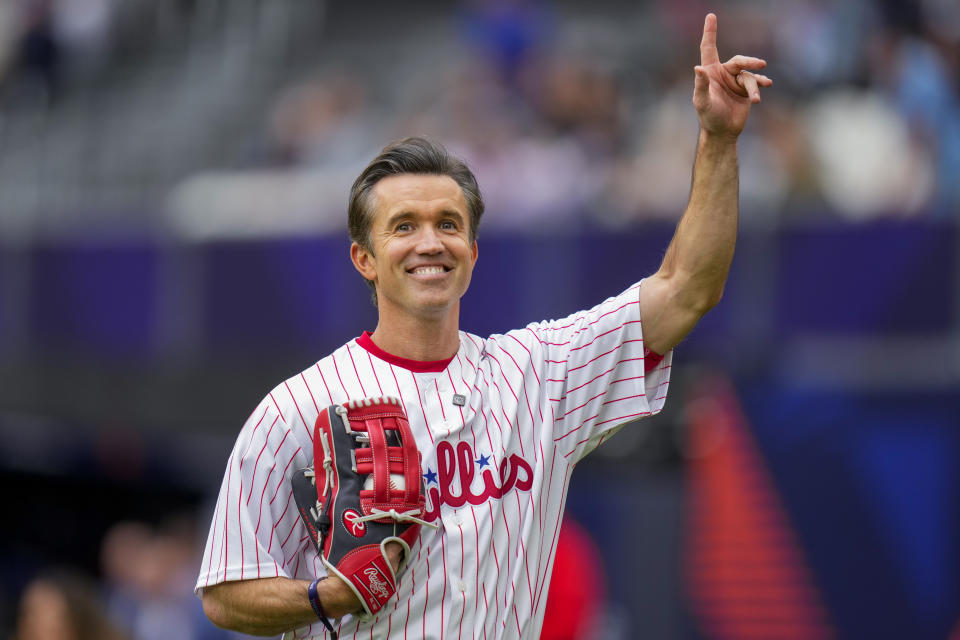 FILE - Actor Rob McElhenney acknowledges the crowd prior to a London Series baseball game between the New York Mets and the Philadelphia Phillies at The London Stadium in London, Sunday, June 9, 2024. McElhenney keeps an eye on the Phillies no matter how far away he is filming TV shows or leading his Wrexham soccer team. He even goofed around with the Phillies on their recent trip to London.(AP Photo/Kirsty Wigglesworth, File)