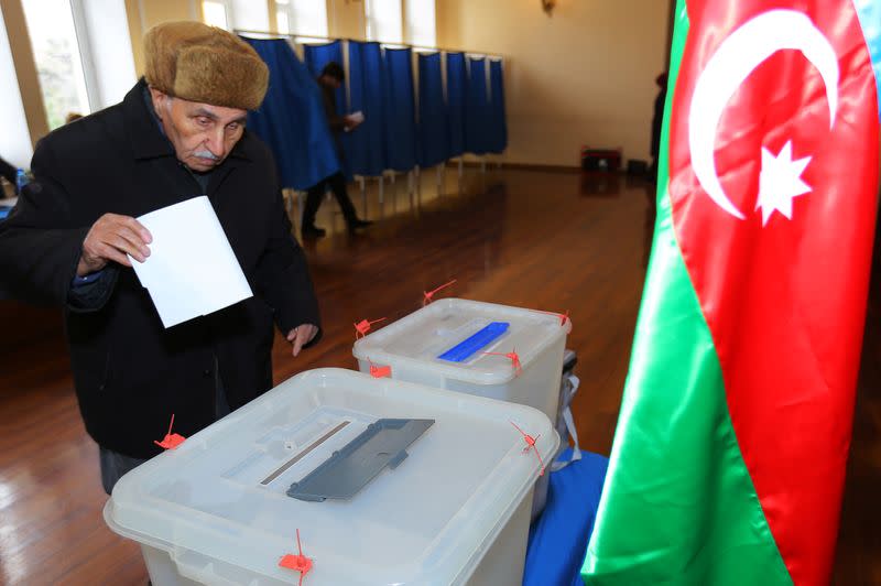 A man casts his vote at a polling station during a snap parliamentary election in Baku