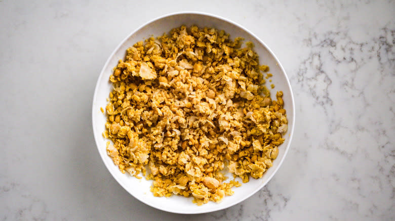 smashed chickpeas in white bowl