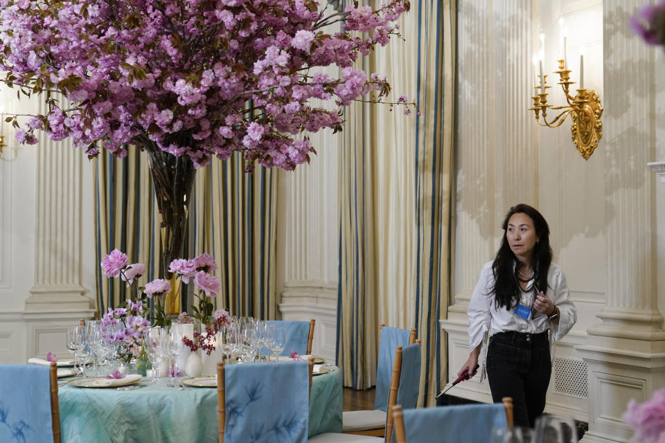 Jung Lee, the Korean American founder and creative director of Fête, walks around table settings during a preview, Monday, April 24, 2023, for Wednesday's State Dinner with South Korea's President Yoon Suk Yeol at the White House in Washington. (AP Photo/Susan Walsh)