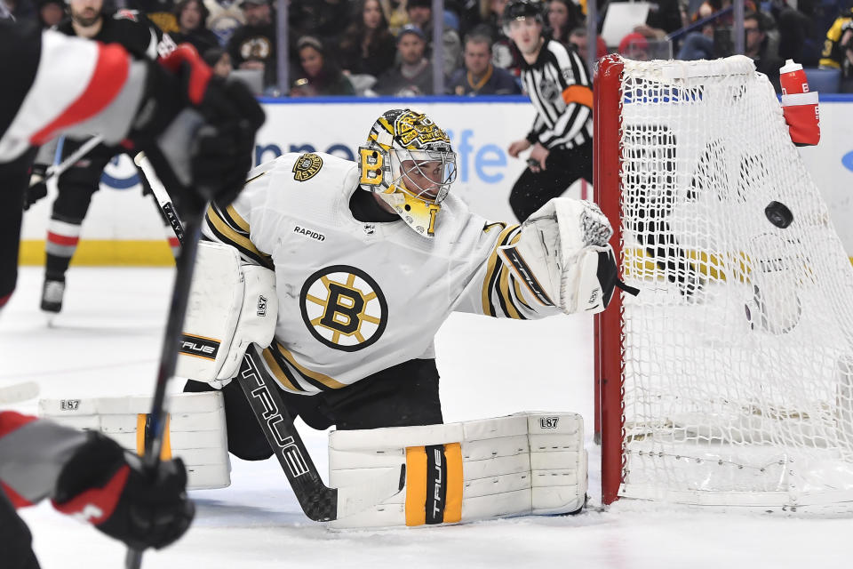 Boston Bruins goalie Jeremy Swayman (1) watches a shot go wide of the net during the second period of the team's NHL hockey game against the Buffalo Sabres in Buffalo, N.Y., Wednesday, Dec. 27, 2023. (AP Photo/Adrian Kraus)