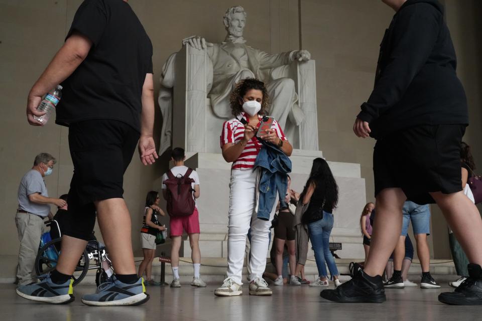 People wear masks at the Lincoln Memorial in Washington on June 7, 2023. Authorities warned residents across much of the Northeast to stay inside and limit or avoid outdoor activities because of smoke from wildfires in Canada.