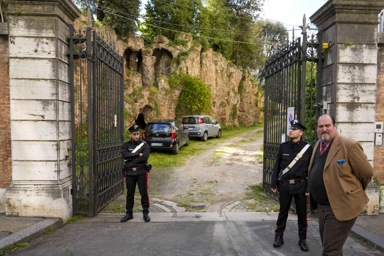 Bante Boncompagni Ludovisi, right, son of Prince Nicolo Boncompagni Ludovisi, and Carabinieri police officers stand in front of The Casino dell'Aurora, also known as Villa Ludovisi, during the execution of an eviction order, in Rome, Thursday, April 20, 2023. Texas-born Princess Rita Boncompagni Ludovisi, who lives in the villa containing the only known ceiling painted by Caravaggio, is facing a court-ordered eviction Thursday, in the latest chapter in an inheritance dispute with the heirs of one of Rome's aristocratic families. (AP Photo/Andrew Medichini)
