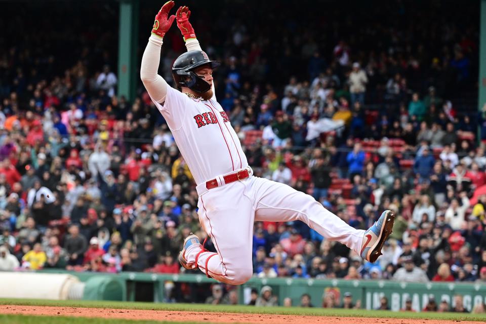 Jun 4, 2023; Boston, Massachusetts, USA; Boston Red Sox right fielder Alex Verdugo (99) slides into third base during the fifth inning against the Tampa Bay Rays at Fenway Park. Mandatory Credit: Eric Canha-USA TODAY Sports