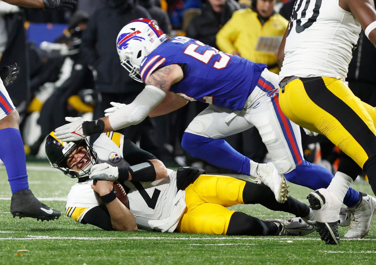 Pittsburgh Steelers quarterback Mason Rudolph (2) slides under the tackle of Buffalo Bills linebacker A.J. Klein (52).