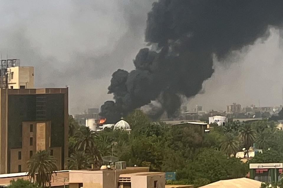 Smoke billows above residential buildings in Khartoum on April 16, 2023, as fighting in Sudan raged for a second day in battles between rival generals.