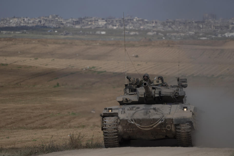 Israeli soldiers move on the top of a tank near the Israeli-Gaza border, as seen from southern Israel, Tuesday, April 9, 2024. (AP Photo/Leo Correa)