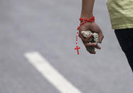 <p>A demonstrator wears a rosary while holding chunks of concrete as clashes broke out as the Constituent Assembly election was being carried out in Caracas, Venezuela, July 30, 2017. (Andres Martinez Casares/Reuters) </p>