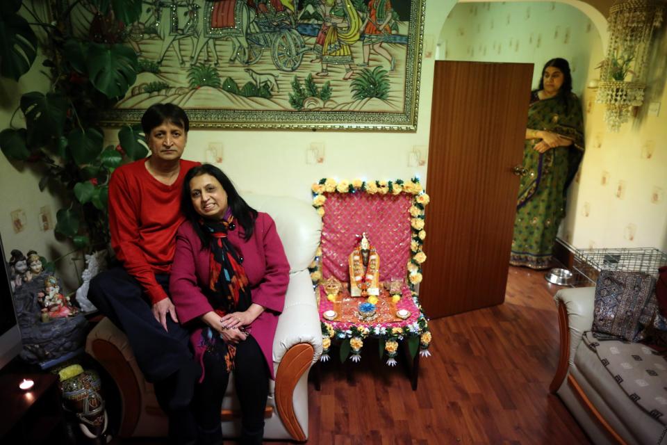 LEICESTER, UNITED KINGDOM - NOVEMBER 13: Residents Suresh Bakrania and his wife Hansa (C) pose as they sit inside their home which is decorated to celebrate the Hindu festival of Diwali on November 13, 2012 in Leicester, United Kingdom. Up to 35,000 people attended the Diwali festival of light in Leicester's Golden Mile in the heart of the city's asian community. The festival is an opportunity for Hindus to honour Lakshmi, the goddess of wealth and other gods. Leicester's celebrations are one of the biggest in the world outside India. Sikhs and Jains also celebrate Diwali. (Photo by Christopher Furlong/Getty Images)
