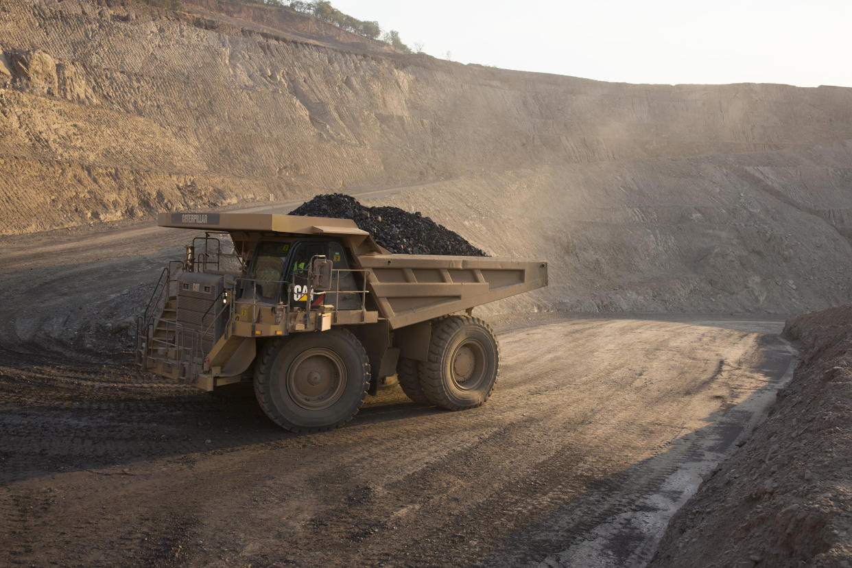 KOLWEZI, DRC- JULY 7: The sun sets on one of the open pit copper mines at Mutanda Mining Sarl on July 6, 2016 in Kolwezi, DRC. The mine is owned (69%) by Glencore, an Anglo-Swiss multinational commodity trading and mining company. The mine is mainly producing copper but also some cobalt. The mine employs about 3,500 people and its located in Luabala Province in Southern DRC. A truck carries a load of ore to the processing plant. (Photo by Per-Anders Pettersson/Getty Images)