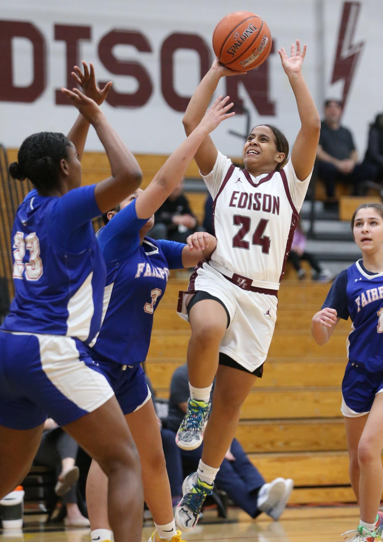 Edison's NaKayla Costello drives to the basket to score over Fairport's Jada Crocker and Amiya Johnson in the first quarter.