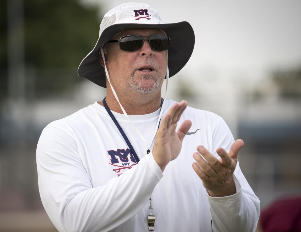 Coach Corbin Smith cheers his team on during football practice, July 31, 2018, at McClintock High School in Tempe.