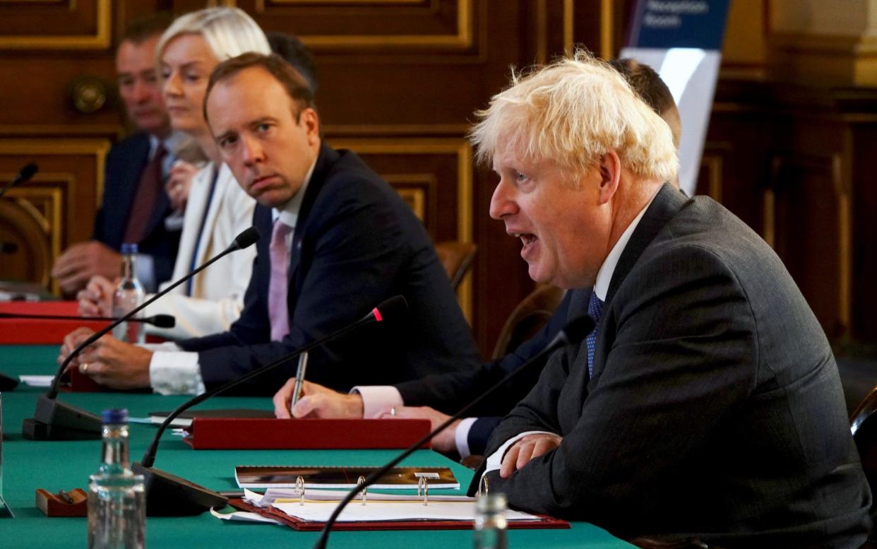 British Prime Minister Boris Johnson (R) speaks as Secretary of State for Health and Social Care, Matt Hancock (C) listens during a Cabinet Meeting at the Foreign & Commonwealth Office - WPA Pool  /Getty 