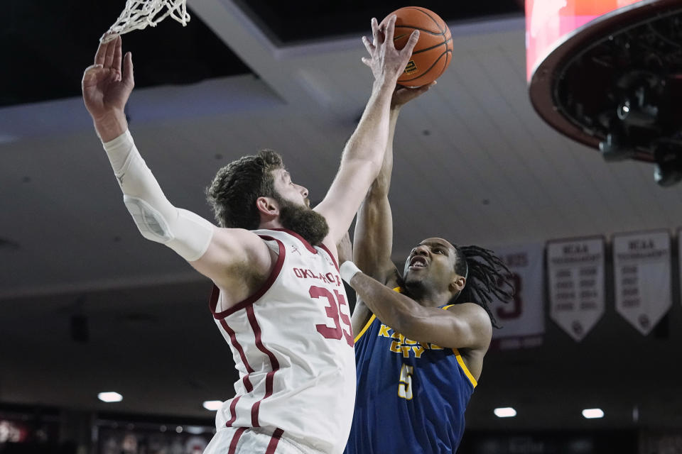 Oklahoma forward Tanner Groves (35) blocks a shot by Kansas City guard Shemarri Allen (5) in the first half of an NCAA college basketball game, Tuesday, Dec. 6, 2022, in Norman, Okla. (AP Photo/Sue Ogrocki)