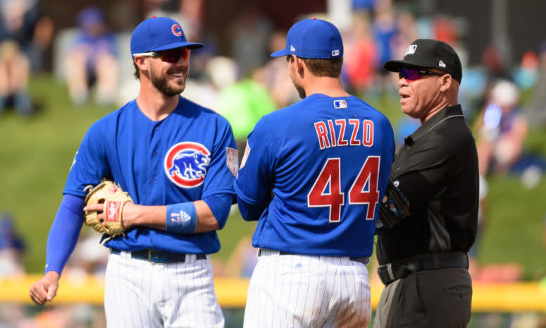 Anthony Rizzo talking to Kris Bryant and an umpire.