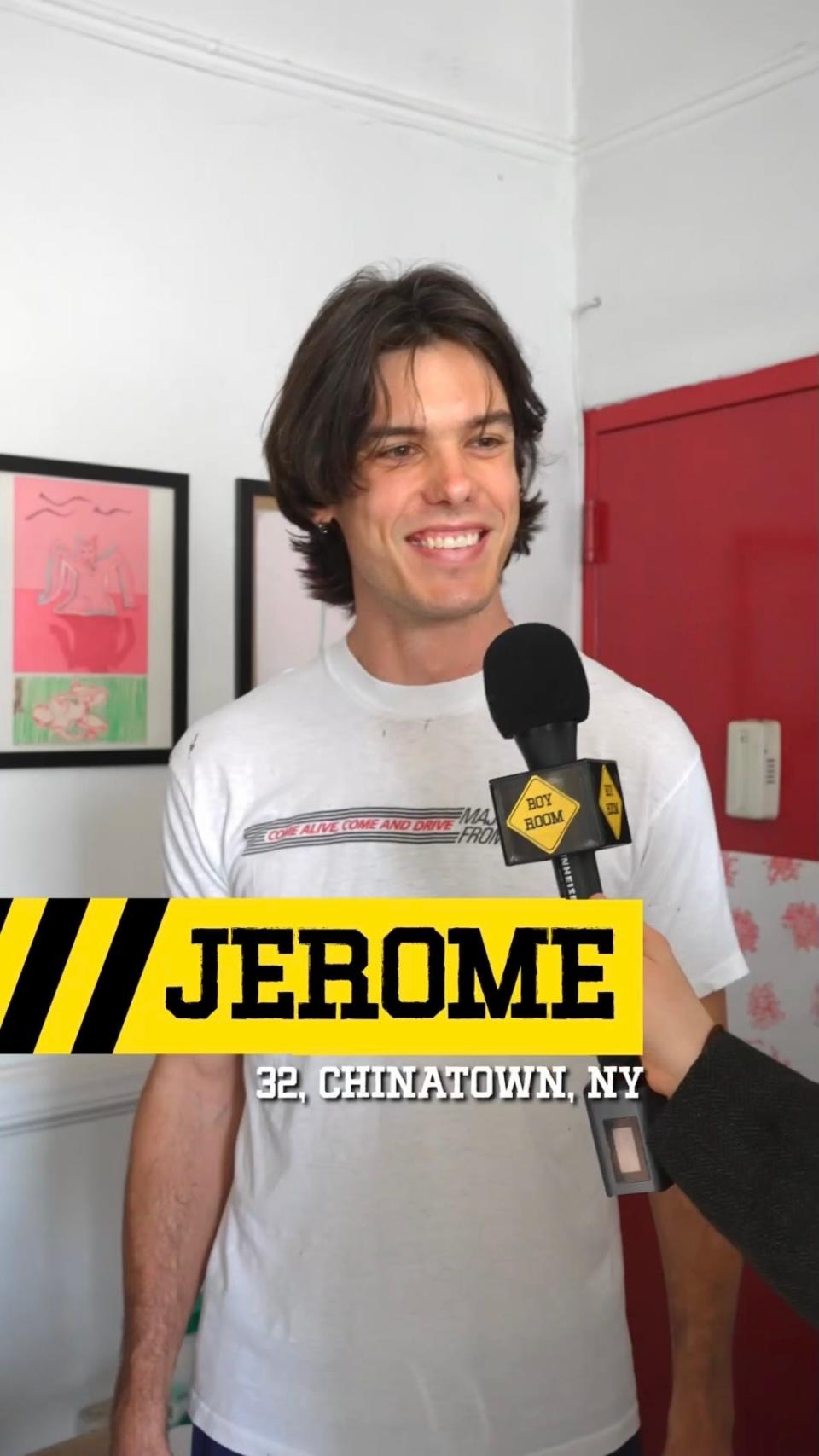 Jerome Peel in a white t-shirt with a black-and-yellow icon showing his name for the Boy Room show.