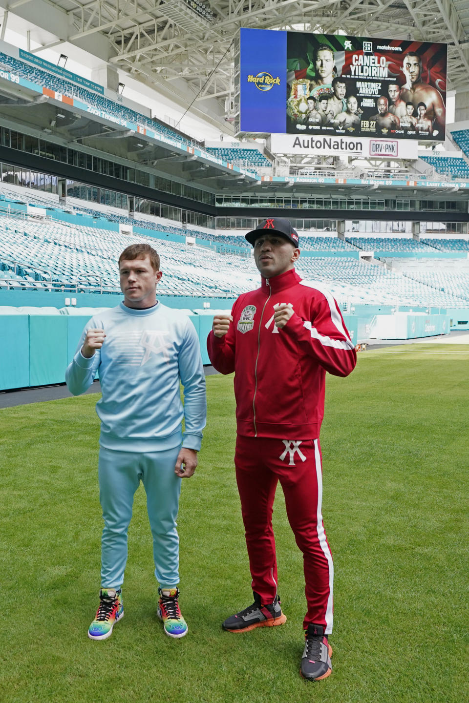 Boxers Saul "Canelo" Alvarez, left, and Avni Yildirim pose for photos at Hard Rock Stadium, Monday, Feb. 22, 2021, in Miami Gardens, Fla. Alvarez will defend his WBC and WBA super-middleweight titles against Yildirim on Saturday. (AP Photo/Marta Lavandier)