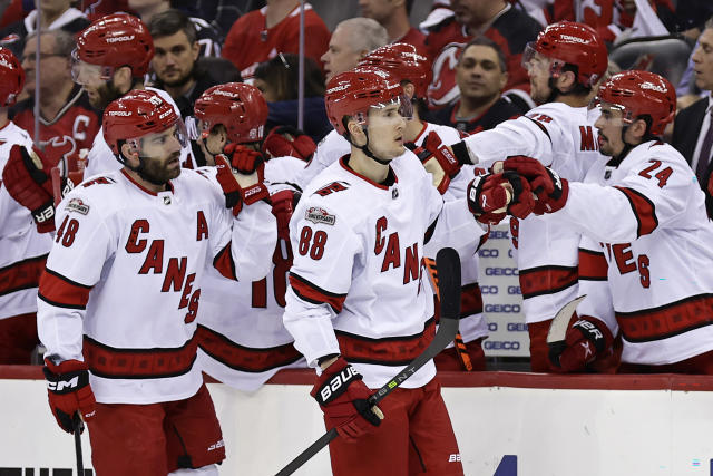 Carolina Hurricanes center Martin Necas (88) celebrates with teammates after scoring a goal against the New Jersey Devils during the first period of Game 4 of an NHL hockey Stanley Cup second-round playoff series Tuesday, May 9, 2023, in Newark, N.J. (AP Photo/Adam Hunger)