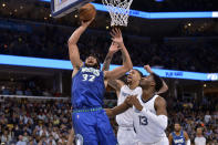 Minnesota Timberwolves center Karl-Anthony Towns (32) next to Memphis Grizzlies forward Jaren Jackson Jr. (13) and center Brandon Clarke during the second half during Game 1 of a first-round NBA basketball playoff series Saturday, April 16, 2022, in Memphis, Tenn. (AP Photo/Brandon Dill)