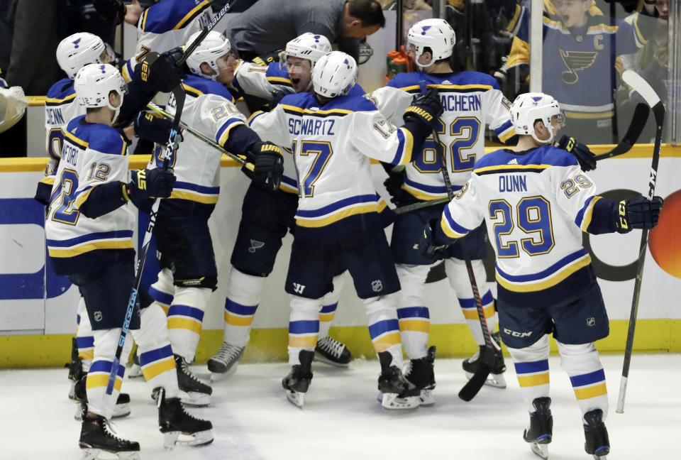 St. Louis Blues right wing Vladimir Tarasenko, of Russia, center, celebrates with teammates after scoring the winning goal in overtime against the Nashville Predators in an NHL hockey game Sunday, Feb. 10, 2019, in Nashville, Tenn. The Blues won in overtime 5-4. (AP Photo/Mark Humphrey)