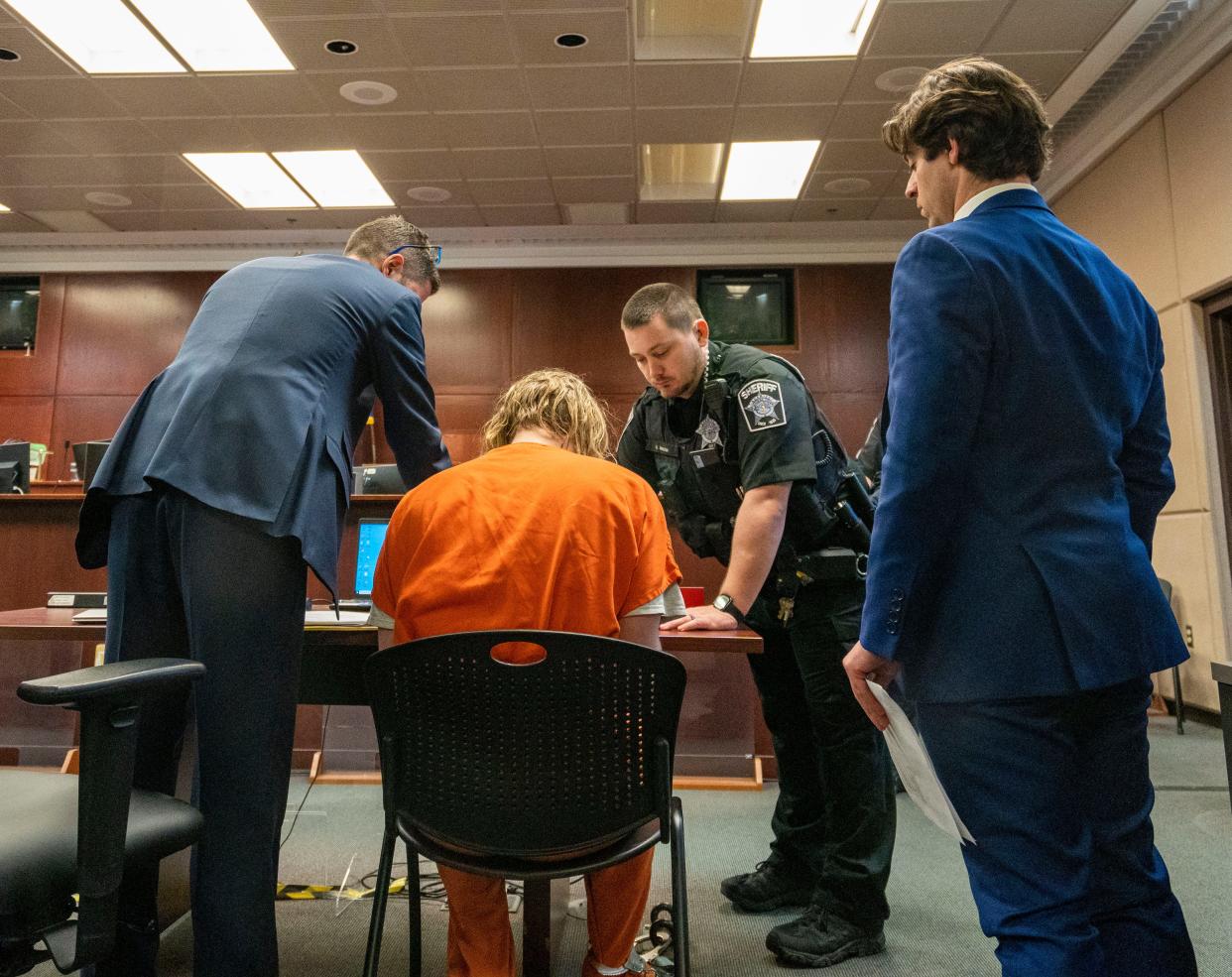 Maxwell Anderson signs paperwork as he is charged with killing and dismembering 19-year-old Sade Carleena Robinson on Friday April 12, 2024 at the Criminal Justice Facility in Milwaukee, Wis.