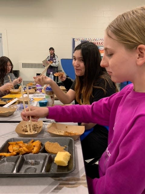Centreville seventh-grade students Tyla Yoder and Nayele Castro-Crespo used chopsticks as they sampled Asian foods Wednesday at Centreville Jr./Sr. High School.