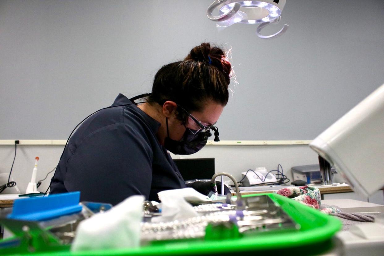 Miranda Krueger, a first-year dental hygiene student at Salina Area Technical College, performs a cleaning.