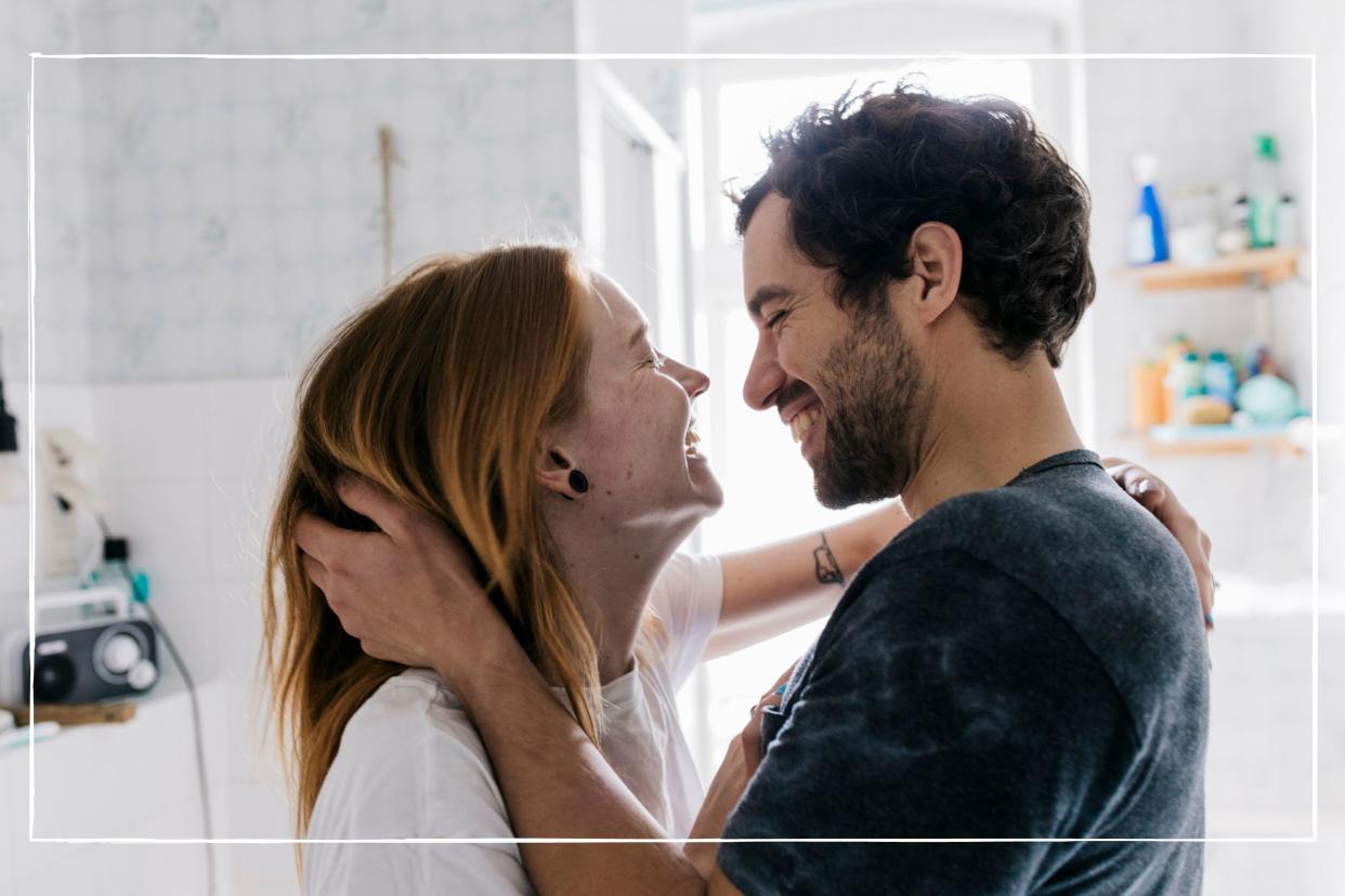  Happy couple facing each other and smiling. 