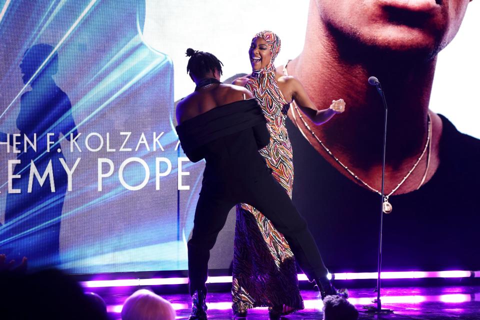 (From left) Jeremy Pope and Gabrielle Union dance onstage at the GLAAD Media Awards.