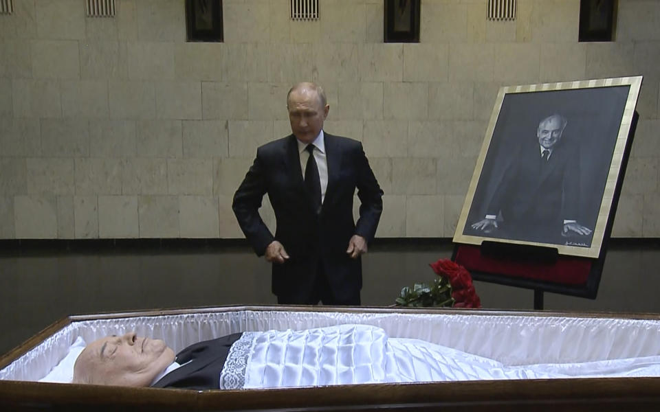 In this image taken from video provided by the Russian pool television on Thursday, Sept. 1, 2022, Russian President Vladimir Putin pays his last respect near the coffin of former Soviet President Mikhail Gorbachev at the Central Clinical Hospital in Moscow Russia. (Russian pool via AP)