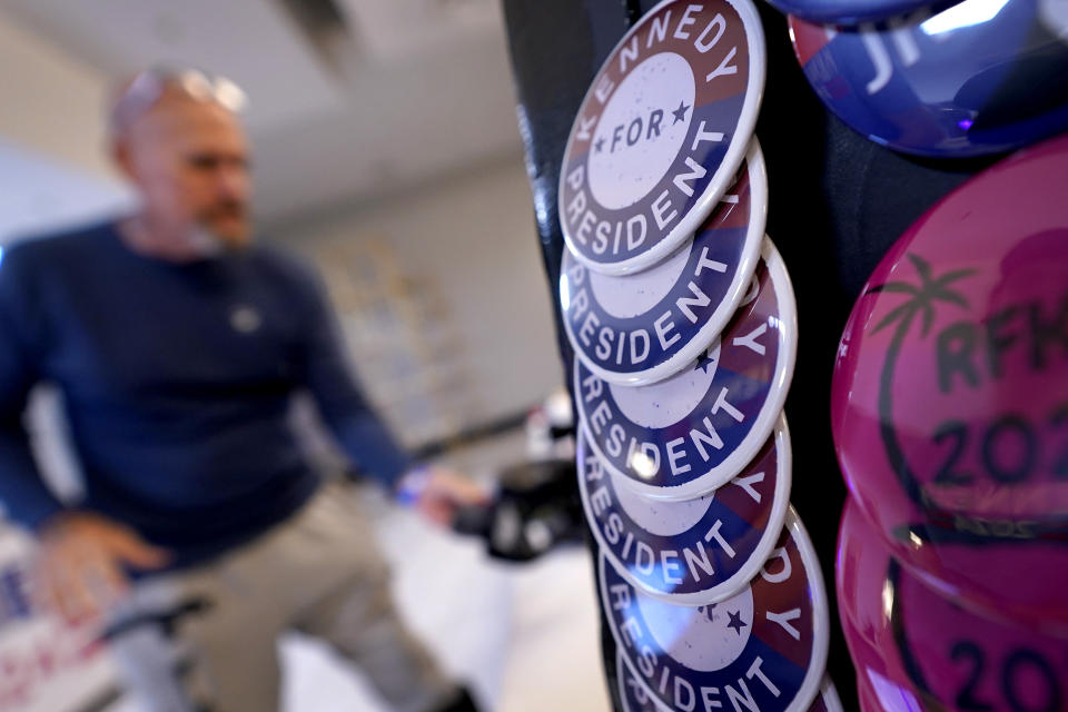 A man purchases a RFK Jr. hat during a voter rally for Independent presidential candidate Robert F. Kennedy Jr., Wednesday, Dec. 20, 2023, in Phoenix. (AP Photo/Matt York)