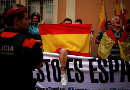 Demonstrators hold up Spanish flags during a gathering in support of Spanish civil guards outside their barracks in Barcelona, Spain, September 21, 2017. REUTERS/Jon Nazca