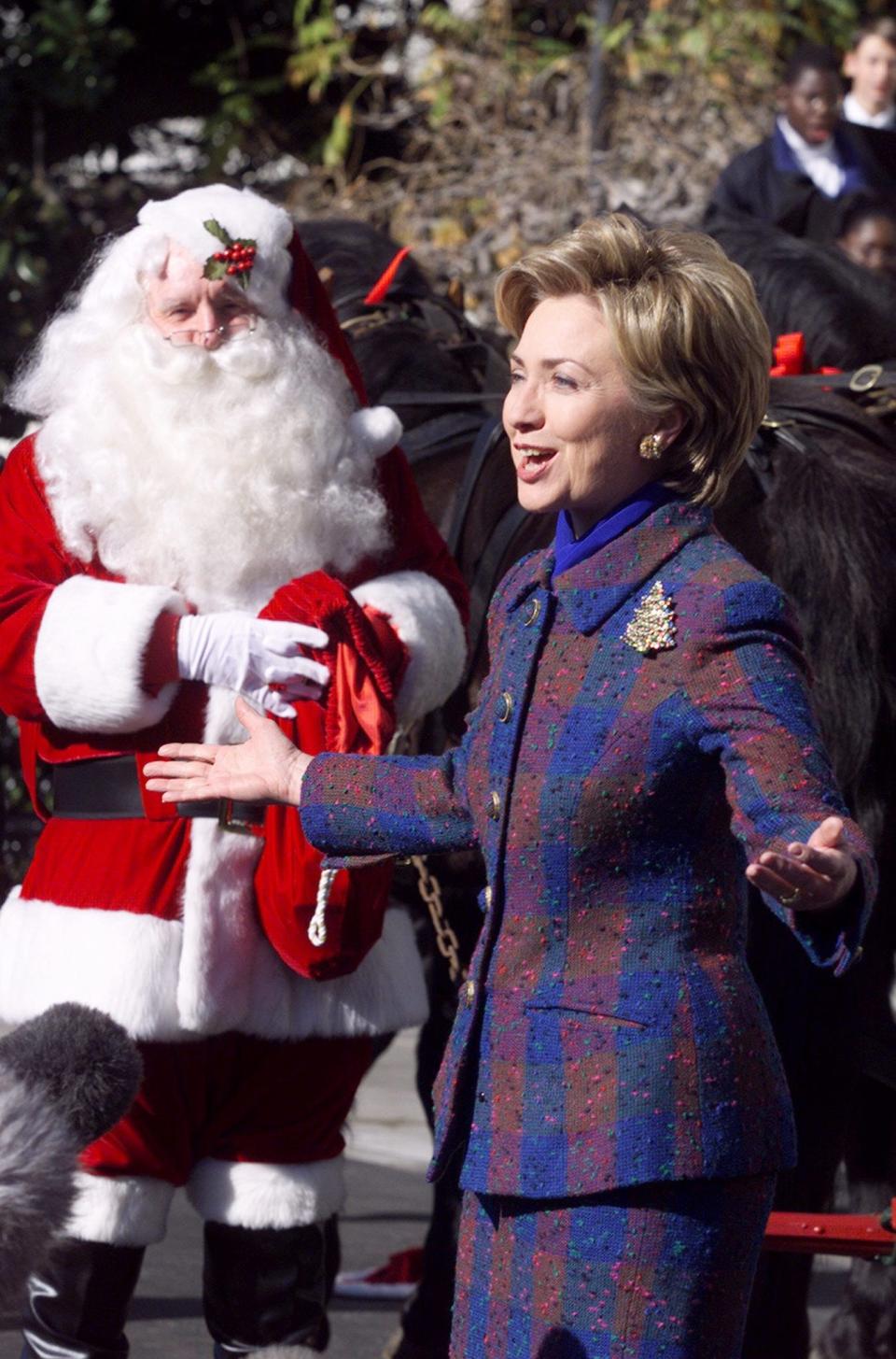 Hillary Clinton stands next to Santa at the White House.