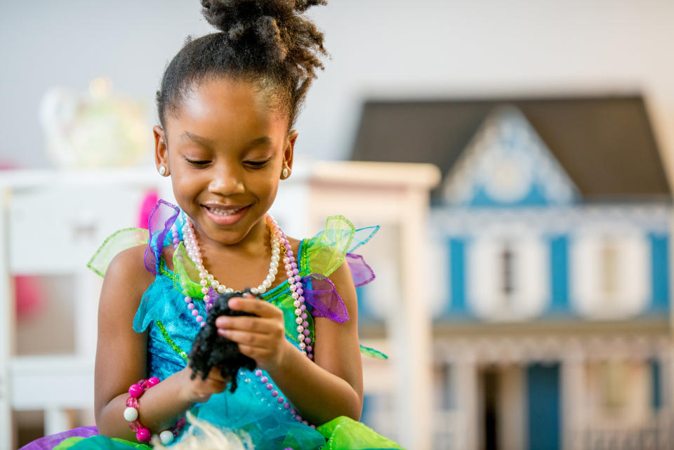 A little girl playing with a toy