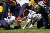 Chicago Bears running back Khalil Herbert, left, and quarterback Justin Fields fall on Fields' fumble during the first half of an NFL football game against the Green Bay Packers Sunday, Oct. 17, 2021, in Chicago. (AP Photo/David Banks)