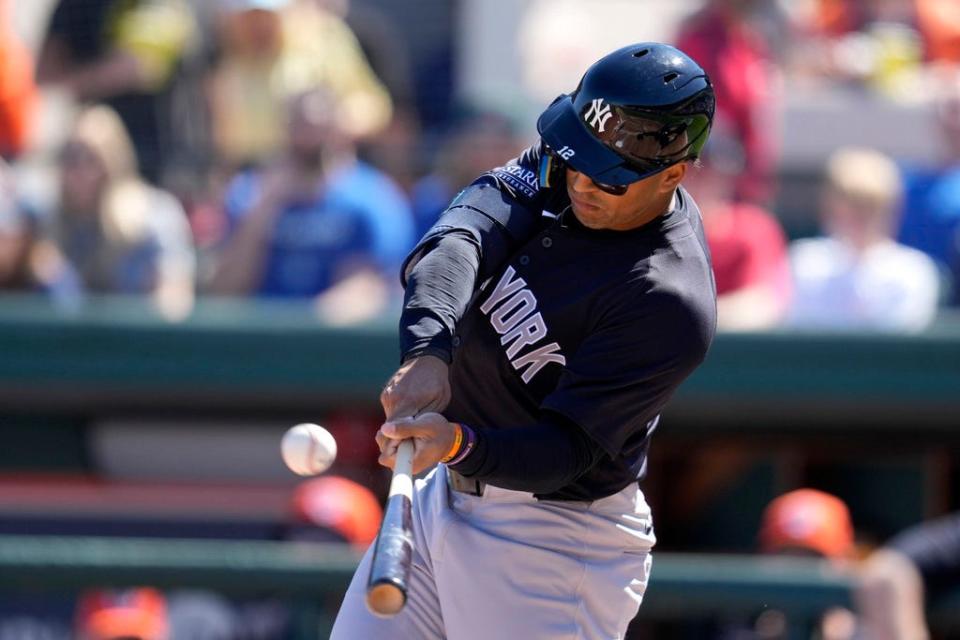 New York Yankees center fielder Trent Grisham (12) flys out during the first inning of a spring training baseball game against the Detroit Tigers Saturday, Feb. 24, 2024, in Lakeland, Fla. (AP Photo/Charlie Neibergall)