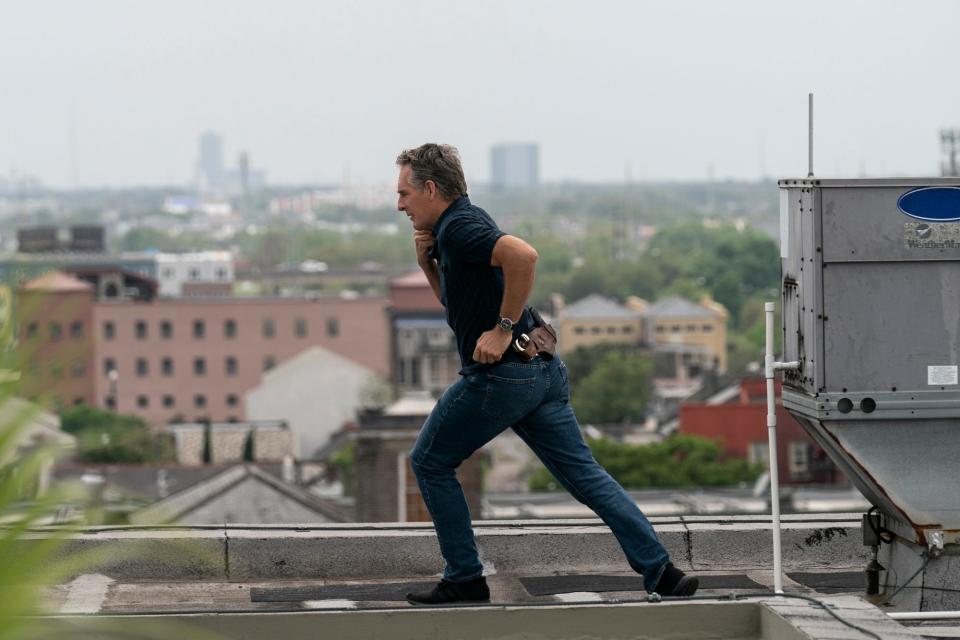 Dwayne Pride pursues a suspect in one last rooftop run against a Crescent City backdrop in the series finale of "NCIS: New Orleans."
