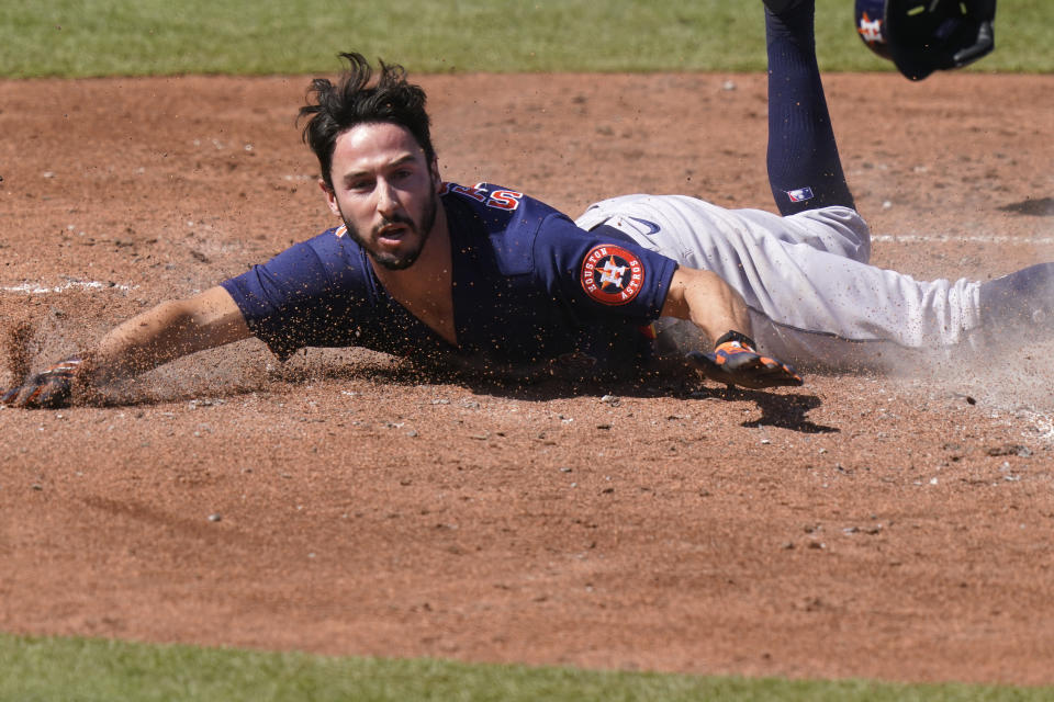 Houston Astros' Garrett Stubbs scores of a double hit by Abraham Toro during the fifth inning of a spring training baseball game against the St. Louis Cardinals, Sunday, March 7, 2021, in Jupiter, Fla. (AP Photo/Lynne Sladky)