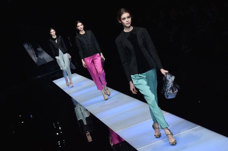 Models present creations for fashion house Giorgio Armani at the Fall/ Winter 2015/16 Milan's Fashion Week on March 2, 2015