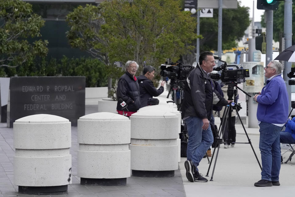 News crews wait outside federal court for Ippei Mizuhara, the former longtime interpreter for Los Angeles Dodgers star Shohei Ohtani, Friday, April 12, 2024, in Los Angeles. Mizuhara is charged with federal bank fraud, alleging that he stole more than $16 million from the Japanese sensation to cover gambling bets and debts, federal authorities said. (AP Photo/Damian Dovarganes)