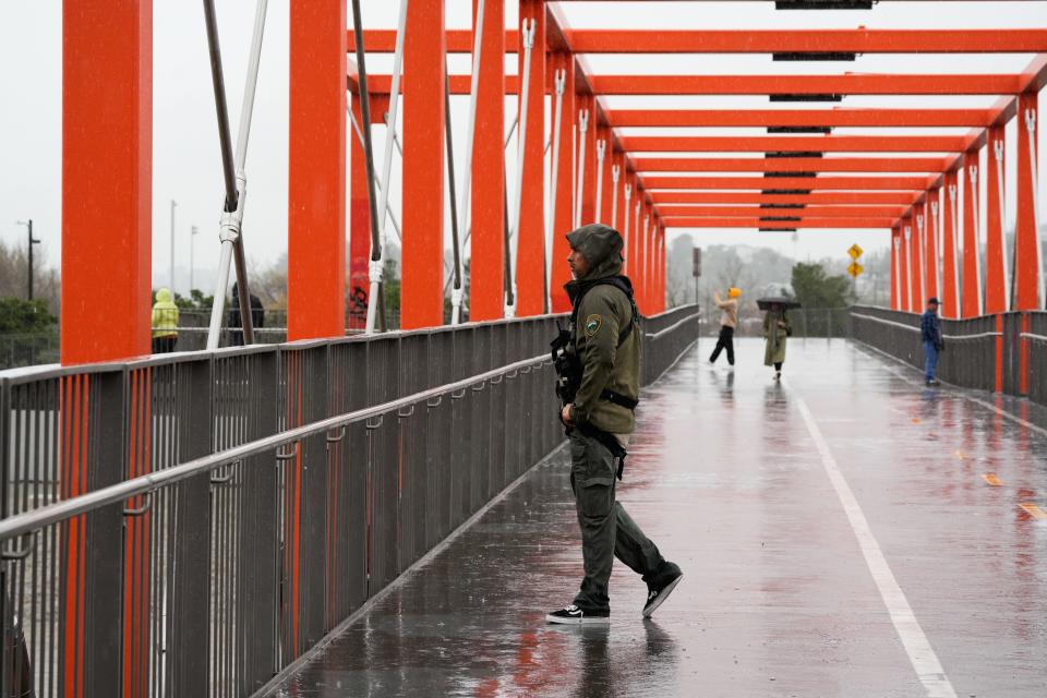 A swift water rescuer with the Mountains Recreation and Conservation Authority patrols the bridges near the Los Angeles River on Feb 5, 2024.
