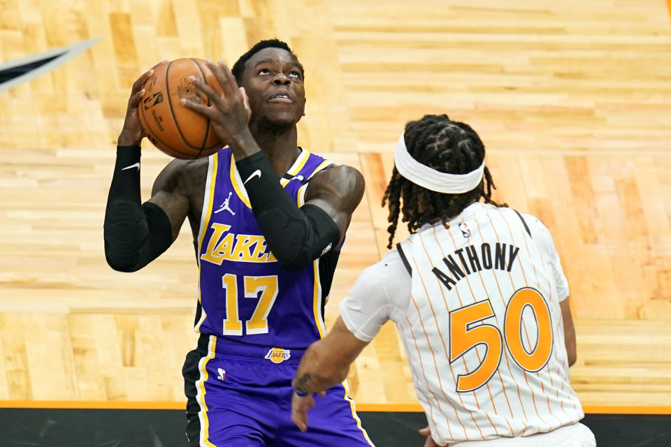 Los Angeles Lakers guard Dennis Schroder (17) looks for a shot against Orlando Magic guard Cole Anthony (50) during the first half of an NBA basketball game, Monday, April 26, 2021, in Orlando, Fla. (AP Photo/John Raoux)