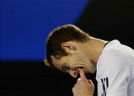 Andy Murray of Britain bites his finger during his men's singles quarter-final tennis match against Roger Federer of Switzerland at the Australian Open 2014 tennis tournament in Melbourne January 22, 2014. REUTERS/Petar Kujundzic/Files
