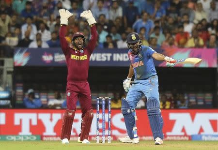 Cricket - West Indies v India - World Twenty20 cricket tournament semi-final - Mumbai, India - 31/03/2016. West Indies wicketkeeper Denesh Ramdin (L) appeals successfully for the wicket of India's Rohit Sharma. REUTERS/Shailesh Andrade -