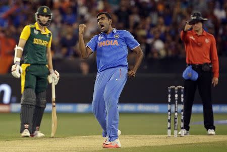 South African batsman Wayne Parnell (L) watches as India's Ravichandran Ashwin (C) celebrates dismissing South Africa's Vernon Philander (unseen) for a duck during their Cricket World Cup match at the Melbourne Cricket Ground (MCG) February 22, 2015. REUTERS/Hamish Blair