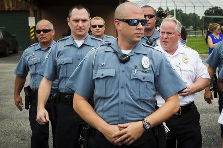 Ferguson Police Chief Thomas Jackson (R) walks away from a media availability regarding his office's handling of the release of information following the shooting of Michael Brown in Ferguson, Missouri August 15, 2014. REUTERS/Lucas Jackson/Files