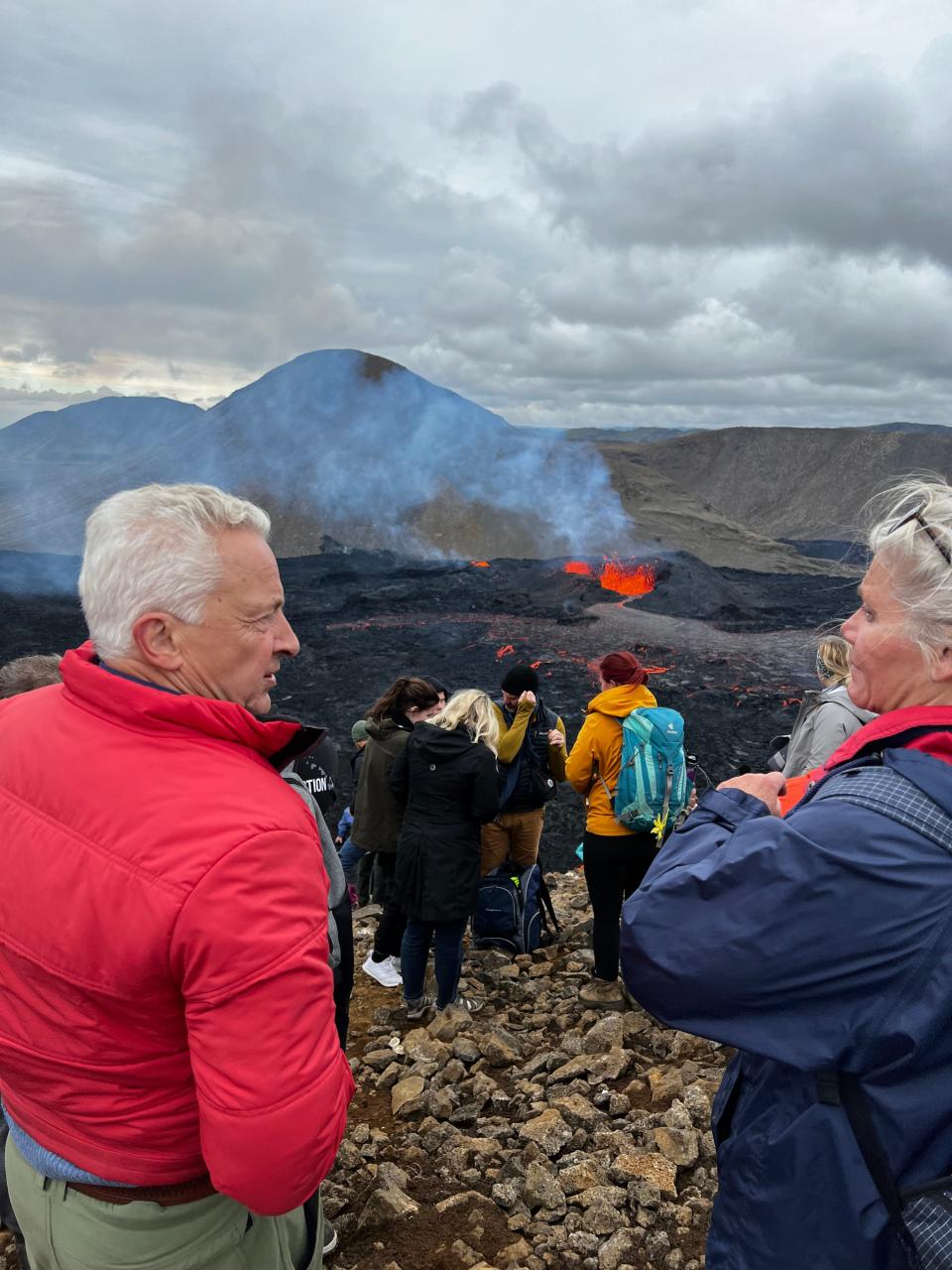 Sigurdur Leosson visits a volcano, which is seen in the background