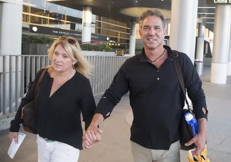 U.S. anti-abortion activist Troy Newman (R) and his wife Melissa Newman arrive after his deportation from Australia at Los Angeles International Airport in Los Angeles, California October 3, 2015. REUTERS/Jonathan Alcorn