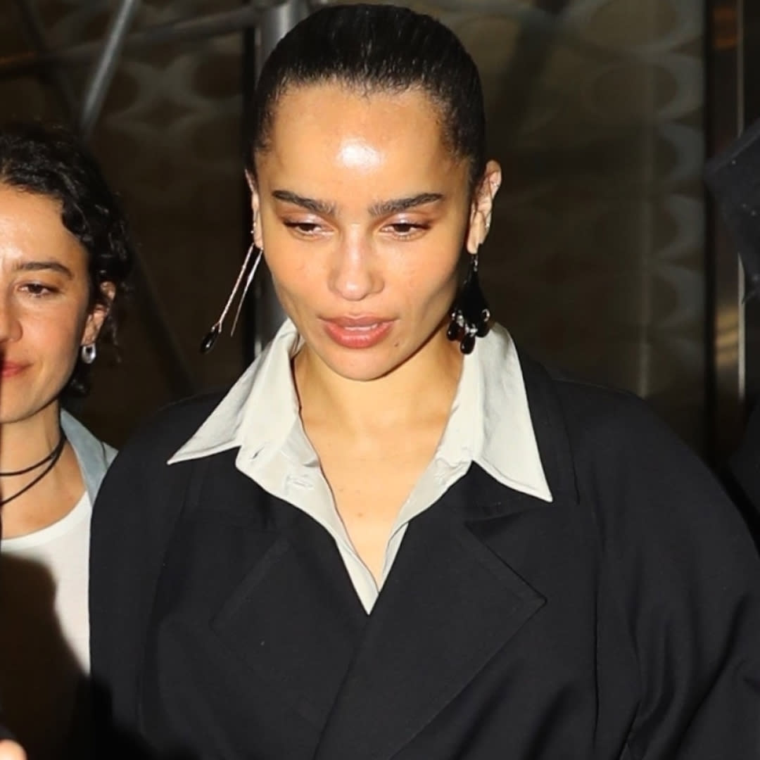  Zoe Kravitz in new york city wearing a black wrap coat and button down shirt. 